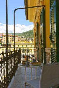 a table on the balcony of a building at Libra Flexyrent in Rapallo