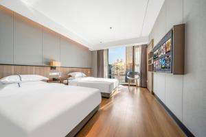 Ένα ή περισσότερα κρεβάτια σε δωμάτιο στο Yangji Yueya Hotel