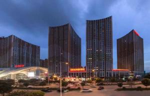 a group of tall buildings in a city at night at Borrman Hotel Nanning Anji Wanda Plaza Sulu Metro Station in Nanning