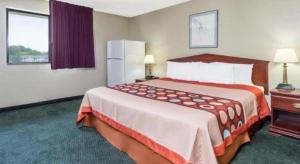 a hotel room with a large bed in a room at Quality Inn & Suites in Bridgeton