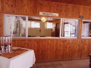 a restaurant with a table and a window at Punyu International Hotel in Khomas Region