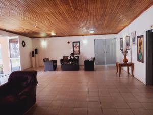 a person sitting on a couch in a living room at Punyu International Hotel in Khomas Region
