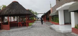 a person walking down a street next to buildings at Punyu International Hotel in Khomas Region