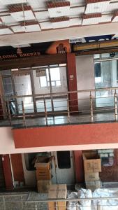 two pictures of a building with boxes on the floor at Hotel Laxmi Nagar in Dera Bassi