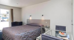 Ένα ή περισσότερα κρεβάτια σε δωμάτιο στο Hawera Central Motor Lodge +53 φωτογραφίες