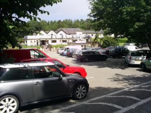 a car parked in a parking lot next to a building at Carreg Bran in Llanfairpwllgwyngyll
