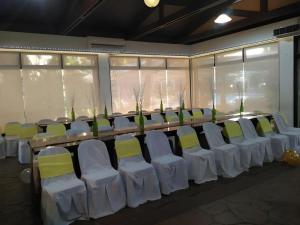 a row of chairs with white and yellow seats at Moonbay Marina the Villas in Olongapo +158 photos