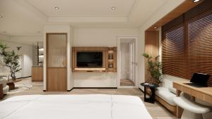 a bedroom with a large bed and a television at Bogorienze City Resort in Pamoyanan