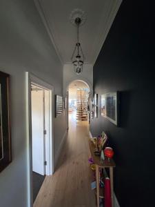 a hallway of a home with a table and a dining room at Inner city quiet cottage in Melbourne