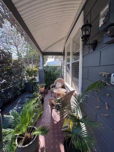 a porch with chairs and plants on a house at Inner city quiet cottage in Melbourne