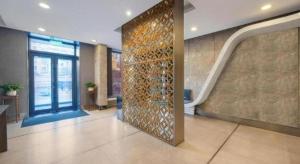 a lobby with a wall of wine bottles on it at JinJiang Inn Datong Pingchengqiao in Datong