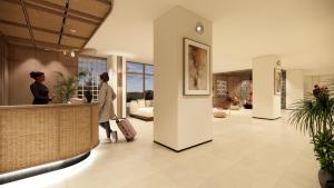 a woman standing at a counter in a lobby at Bogorienze City Resort in Pamoyanan