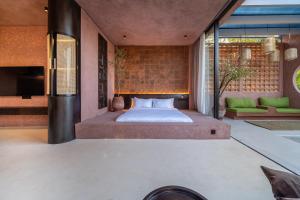 a bedroom with a bed in the middle of a room at Fengshui-1 Serene 1BR Stay in Ungasan in Uluwatu