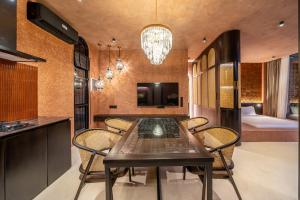 a kitchen and dining room with a table and chairs at Fengshui-1 Serene 1BR Stay in Ungasan in Uluwatu