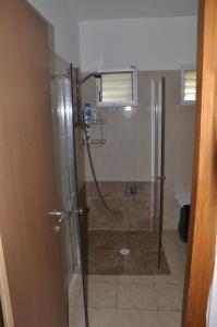 a shower with a glass door in a bathroom at Nadia Hosting Dead Sea in Neve Zohar