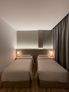 Ένα ή περισσότερα κρεβάτια σε δωμάτιο στο Innara Premium Guest House - Palangkaraya +17 φωτογραφίες