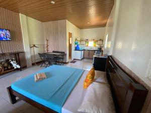 a bedroom with a large blue bed in a room at Happy's Homestay in Boracay
