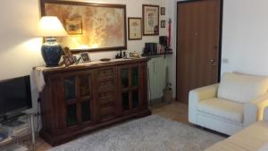 a living room with a television and a couch and a chair at Suite Civitanova in Civitanova Marche