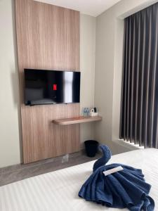 a hotel room with a bed with a towel on it at Hotel Cengkareng Inn in Jakarta