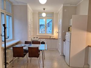 a kitchen and dining room with a table and chairs at Luxhousing apartment with balcony in Helsinki