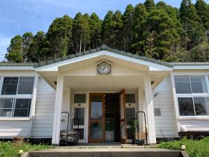 a building with a clock on the top of it at 里山のいぶき舎 in Goto