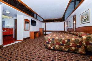 a hotel room with a bed and a bathroom at Americas Best Value Inn & Suites Los Angeles Downtown SW in Los Angeles