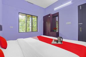 Ένα ή περισσότερα κρεβάτια σε δωμάτιο στο Collection O Clement Holydays