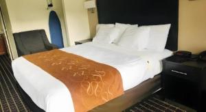 a hotel room with a bed with a blanket on it at Baymont by Wyndham Acworth in Acworth