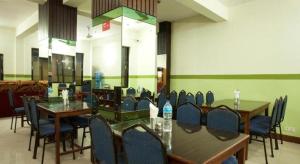 a dining room with tables and chairs in a room at OYO 381 Hotel Pashupati Plaza in Pashupatināth
