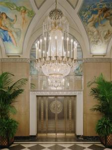 a large chandelier in a room with a large door at Waldorf Astoria New York in New York +98 photos