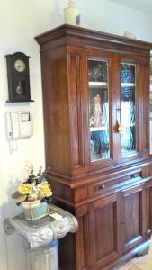 a large wooden cabinet in a room with a table at Suite Civitanova in Civitanova Marche