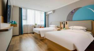 Ένα ή περισσότερα κρεβάτια σε δωμάτιο στο City Comfort Inn Nanning Guangxi University +192 φωτογραφίες