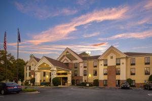 a hotel with cars parked in a parking lot at Comfort Inn & Suites Spartanburg North in Spartanburg