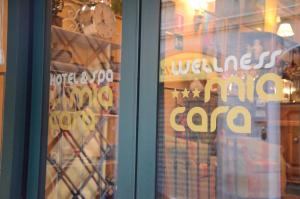 a store window with a sign on the glass at Hotel Mia Cara & Spa in Florence