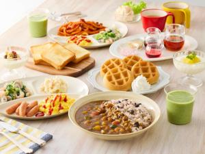 Una mesa con muchos platos de comida encima. en Comfort Inn Niigata Kameda, en Niigata 19 fotos más