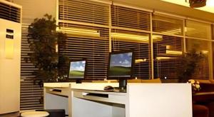 a computer desk with two monitors on top of it at Hotel Formosa in Malalayang