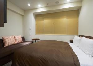 Ένα ή περισσότερα κρεβάτια σε δωμάτιο στο unito hotel residence Kyoto Station North +25 φωτογραφίες