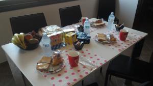 a white table with food and drinks on it at Su AlevraXi in Villagrande Strisaili
