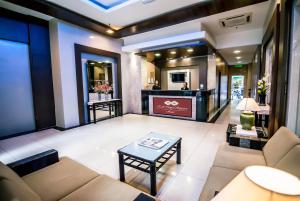 a living room with a couch and a table at KK Times Square Hotel in Kota Kinabalu