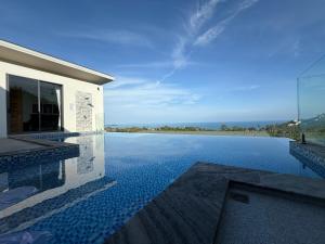 a swimming pool with a view of the ocean at Sea view Villa Josefina - 3 bedroom in Nathon Bay