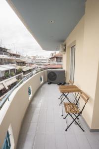 - Balcón con mesa y sillas en un edificio en Larissa Luxury Suite, en Larisa