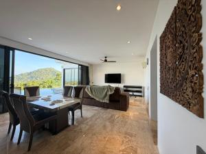 a dining room and living room with a table and chairs at Sea view Villa Josefina - 3 bedroom in Nathon Bay