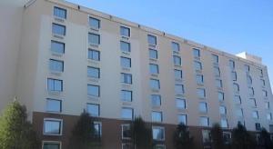 a large white building with a lot of windows at Garden Plaza Hotel in Passaic Junction