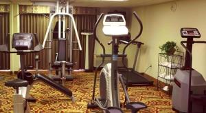 a gym with several exercise equipment in a room at Garden Plaza Hotel in Passaic Junction
