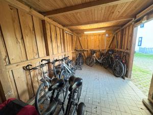 a group of bikes parked in a wooden barn at Ferienwohnung Sonnenperle - Wohnung 13 in Breege