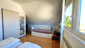 a small bedroom with a bed and a window at Fewo Weitblick - helle Wohnung, 2 SZ, Wasserblick in Breege