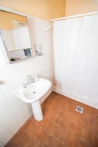 a bathroom with a white sink and a shower at Casa Guaymare in Mendoza