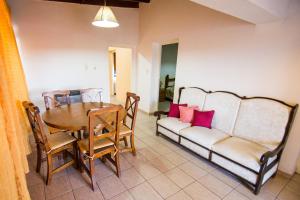 a dining room with a table and a couch at Casa Guaymare in Mendoza
