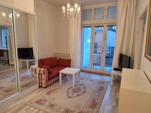 a living room with a red couch and a table at Luxhousing apartment with balcony in Helsinki