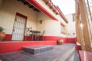 a porch of a building with a table and chairs at Casa Guaymare in Mendoza